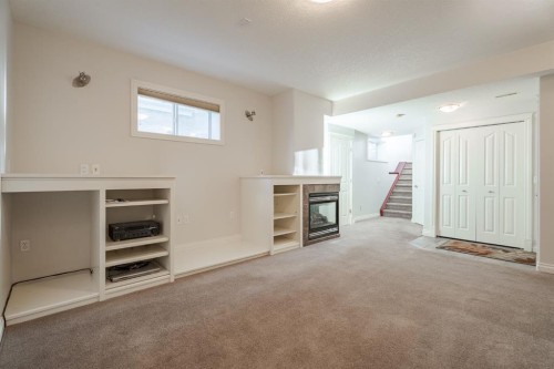 14 Discovery Woods Villas Sw, Calgary, AB - Indoor With Fireplace
