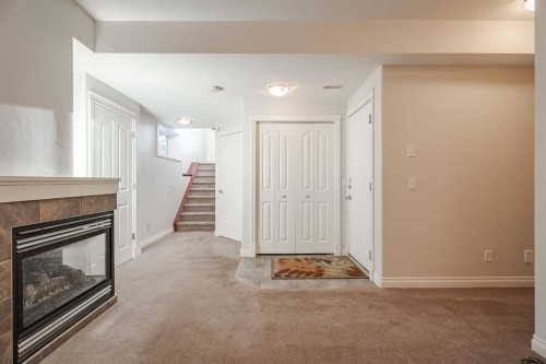 14 Discovery Woods Villas Sw, Calgary, AB - Indoor With Fireplace