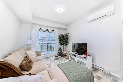 2401-42 Cranbrook Gardens Se, Calgary, AB - Indoor Photo Showing Living Room With Fireplace