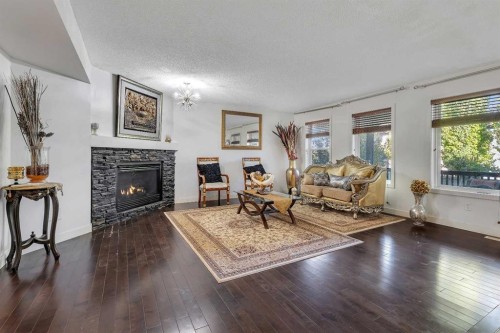 135 Panatella Close Nw, Calgary, AB - Indoor Photo Showing Living Room With Fireplace