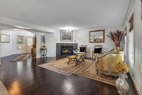 135 Panatella Close Nw, Calgary, AB - Indoor Photo Showing Living Room With Fireplace