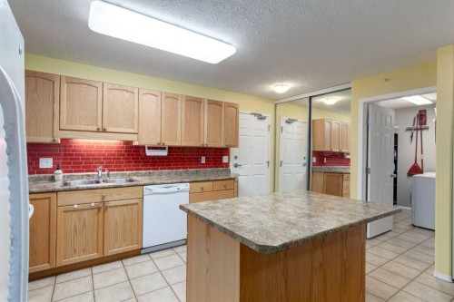 406-99 Westview Drive, Nanton, AB - Indoor Photo Showing Kitchen With Double Sink