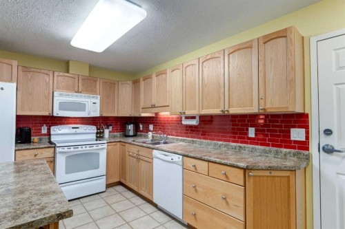 406-99 Westview Drive, Nanton, AB - Indoor Photo Showing Kitchen With Double Sink
