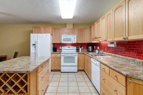 406-99 Westview Drive, Nanton, AB - Indoor Photo Showing Kitchen With Double Sink