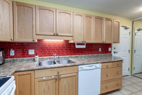 406-99 Westview Drive, Nanton, AB - Indoor Photo Showing Kitchen With Double Sink