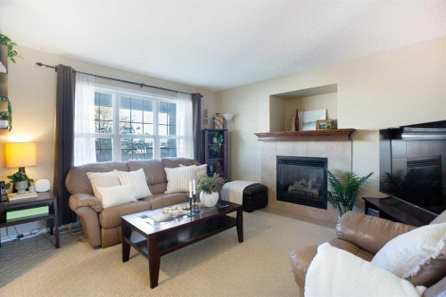 444 Morningside Way Sw, Airdrie, AB - Indoor Photo Showing Living Room With Fireplace