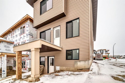 116 Heritage Manor, Cochrane, AB - Outdoor With Facade