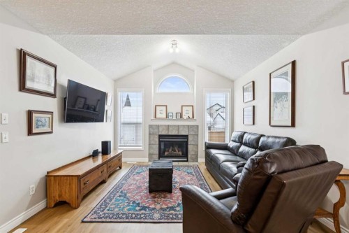 45 Prestwick Rise Se, Calgary, AB - Indoor Photo Showing Living Room With Fireplace