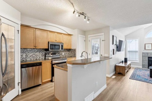 45 Prestwick Rise Se, Calgary, AB - Indoor Photo Showing Kitchen With Fireplace With Stainless Steel Kitchen With Upgraded Kitchen