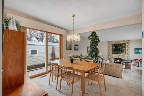 5602 Dalcastle Hill Nw, Calgary, AB - Indoor Photo Showing Dining Room With Fireplace