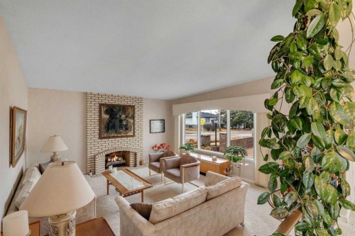5602 Dalcastle Hill Nw, Calgary, AB - Indoor Photo Showing Living Room With Fireplace