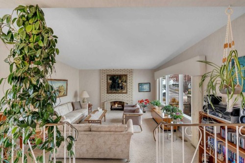 5602 Dalcastle Hill Nw, Calgary, AB - Indoor Photo Showing Living Room With Fireplace