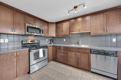 126 Windstone Avenue Sw, Airdrie, AB - Indoor Photo Showing Kitchen With Double Sink