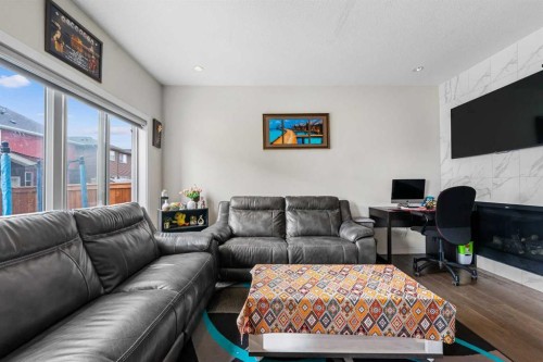 235 Saddlestone Grove Ne, Calgary, AB - Indoor Photo Showing Living Room With Fireplace