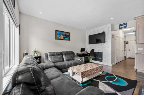 235 Saddlestone Grove Ne, Calgary, AB - Indoor Photo Showing Living Room With Fireplace