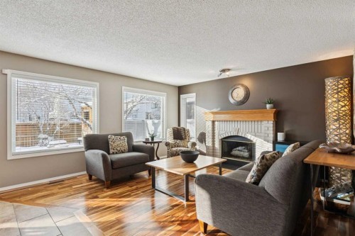 33 River Rock Crescent Se, Calgary, AB - Indoor Photo Showing Living Room With Fireplace
