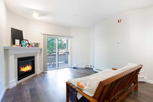 306-777 3 Avenue Sw, Calgary, AB - Indoor Photo Showing Living Room With Fireplace