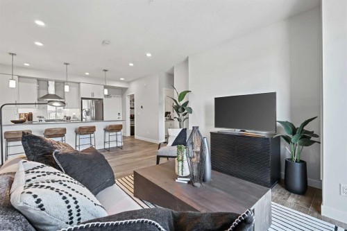 305-255 Les Jardins Park Se, Calgary, AB - Indoor Photo Showing Living Room