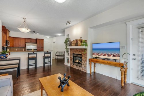 202-10 Discovery Ridge Close Sw, Calgary, AB - Indoor Photo Showing Living Room With Fireplace