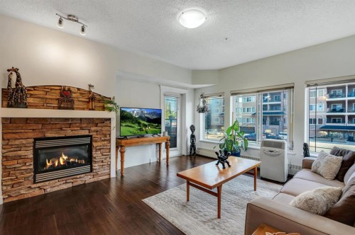 202-10 Discovery Ridge Close Sw, Calgary, AB - Indoor Photo Showing Living Room With Fireplace