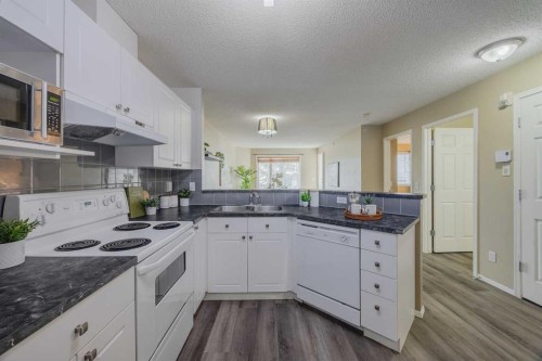 1311-950 Arbour Lake Road Nw, Calgary, AB - Indoor Photo Showing Kitchen