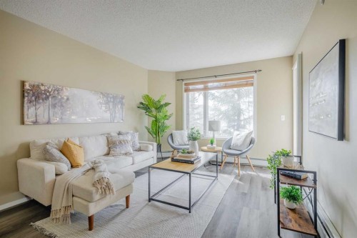 1311-950 Arbour Lake Road Nw, Calgary, AB - Indoor Photo Showing Living Room
