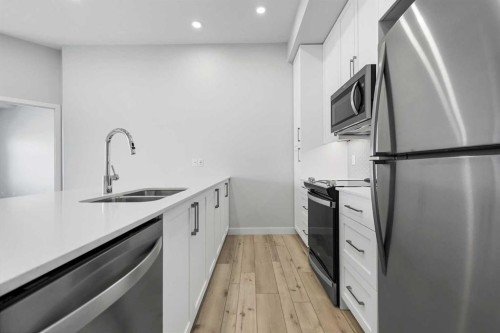 408-255 Les Jardins Park Se, Calgary, AB - Indoor Photo Showing Kitchen With Stainless Steel Kitchen With Double Sink With Upgraded Kitchen