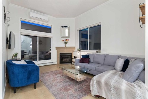 207-881 15 Avenue Sw, Calgary, AB - Indoor Photo Showing Living Room With Fireplace