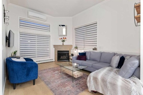 207-881 15 Avenue Sw, Calgary, AB - Indoor Photo Showing Living Room With Fireplace