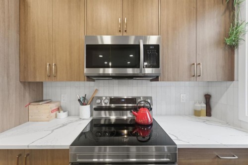 208-562 Seton Circle Se, Calgary, AB - Indoor Photo Showing Kitchen With Double Sink
