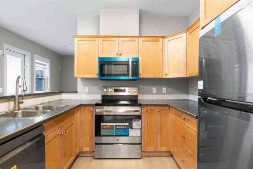 115-1414 17 Street Se, Calgary, AB - Indoor Photo Showing Kitchen With Stainless Steel Kitchen With Double Sink