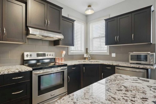 109 Crystal Green Bay, Okotoks, AB - Indoor Photo Showing Kitchen With Upgraded Kitchen