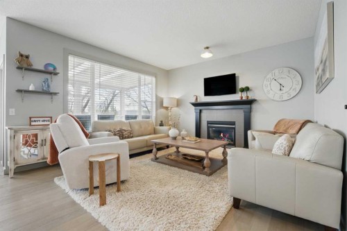 109 Crystal Green Bay, Okotoks, AB - Indoor Photo Showing Living Room With Fireplace