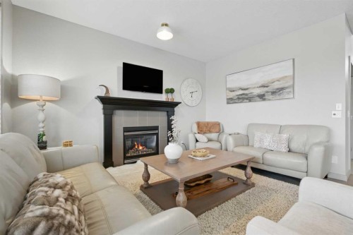 109 Crystal Green Bay, Okotoks, AB - Indoor Photo Showing Living Room With Fireplace