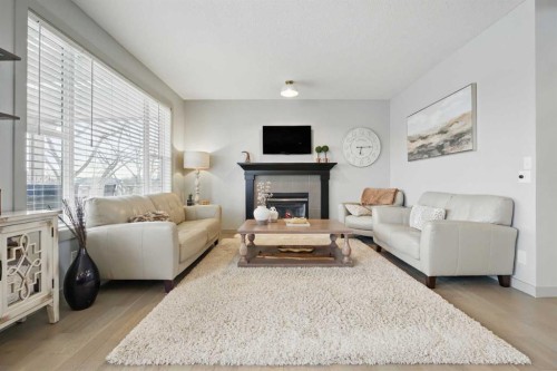 109 Crystal Green Bay, Okotoks, AB - Indoor Photo Showing Living Room With Fireplace