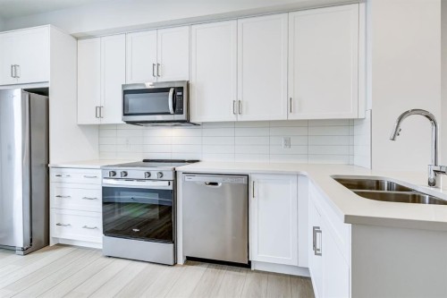 202-437 Alpine Avenue Sw, Calgary, AB - Indoor Photo Showing Kitchen With Stainless Steel Kitchen With Double Sink With Upgraded Kitchen