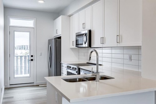 202-437 Alpine Avenue Sw, Calgary, AB - Indoor Photo Showing Kitchen With Double Sink With Upgraded Kitchen
