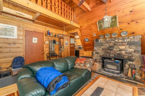 77 Grotto Road, Harvie Heights, AB - Indoor Photo Showing Living Room With Fireplace