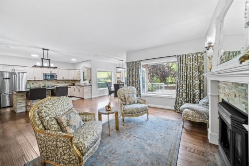 187 Gleneagles View, Cochrane, AB - Indoor Photo Showing Living Room With Fireplace