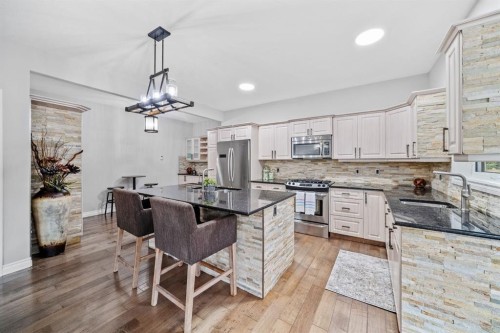 187 Gleneagles View, Cochrane, AB - Indoor Photo Showing Kitchen With Upgraded Kitchen