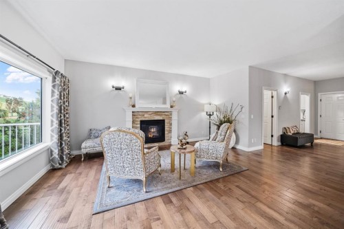 187 Gleneagles View, Cochrane, AB - Indoor Photo Showing Living Room With Fireplace