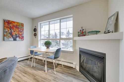 438-35 Richard Court Sw, Calgary, AB - Indoor Photo Showing Dining Room With Fireplace