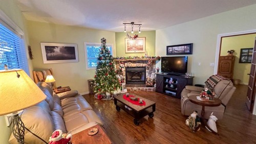 169-5227 Township Road 320, Rural Mountain View County, AB - Indoor Photo Showing Living Room With Fireplace