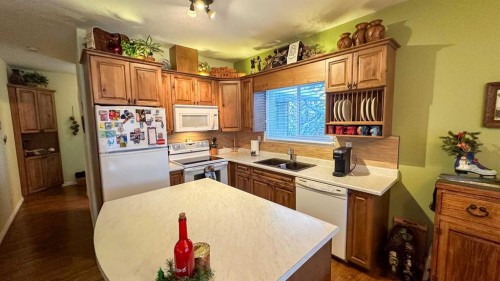 169-5227 Township Road 320, Rural Mountain View County, AB - Indoor Photo Showing Kitchen With Double Sink