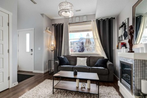 415 Saddlemont Boulevard Ne, Calgary, AB - Indoor Photo Showing Living Room With Fireplace