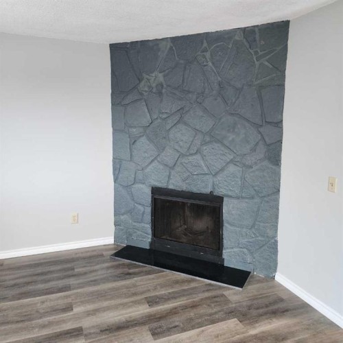 B-1404 43 Street Se, Calgary, AB - Indoor Photo Showing Living Room With Fireplace