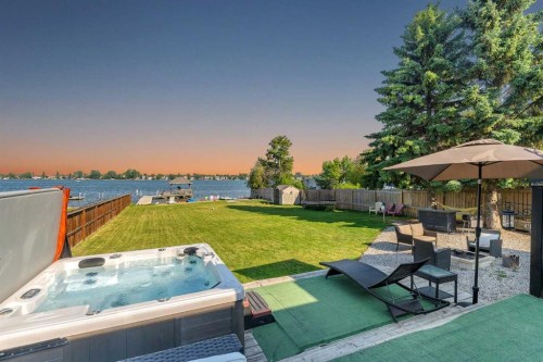 700 West Chestermere Drive, Chestermere, AB - Outdoor With Body Of Water With Deck Patio Veranda With Backyard