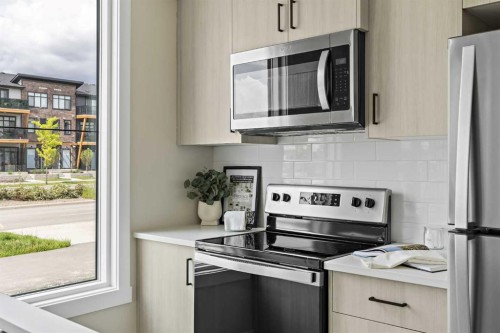 253-380 Seton Villas Se, Calgary, AB - Indoor Photo Showing Kitchen With Stainless Steel Kitchen