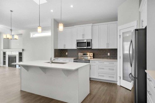 136 Drake Landing Gardens, Okotoks, AB - Indoor Photo Showing Kitchen With Stainless Steel Kitchen With Upgraded Kitchen