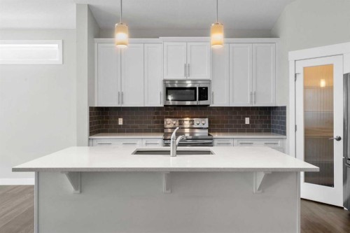 136 Drake Landing Gardens, Okotoks, AB - Indoor Photo Showing Kitchen With Double Sink With Upgraded Kitchen